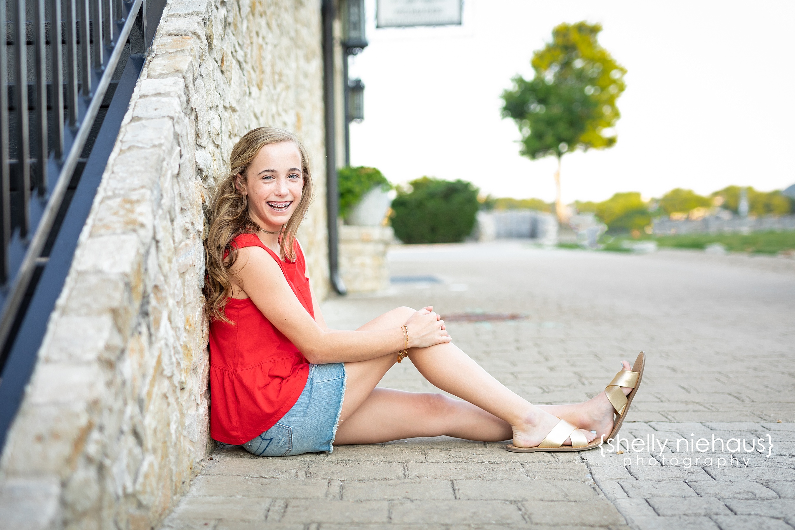 Tween photo session with 13 year old girl in red shirt and blue top in McKinney, TX by Shelly Niehaus Photography.